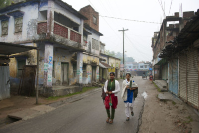 Two girls walk down a street in Puthia,,Bangladesh
