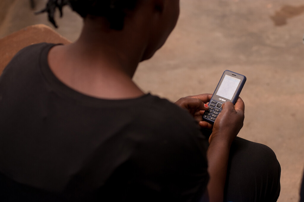 A person uses their phone to engage in nudge messaging in West Africa. Image Credit: EdTech Hub. 