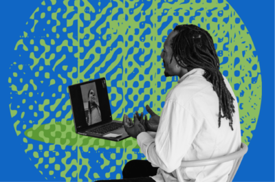 Man working on laptop with green background and blue underlay