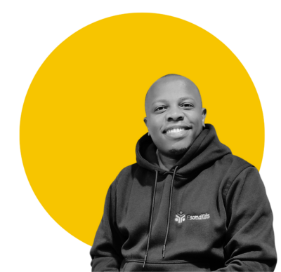 Person posing for the camera in front of a yellow background